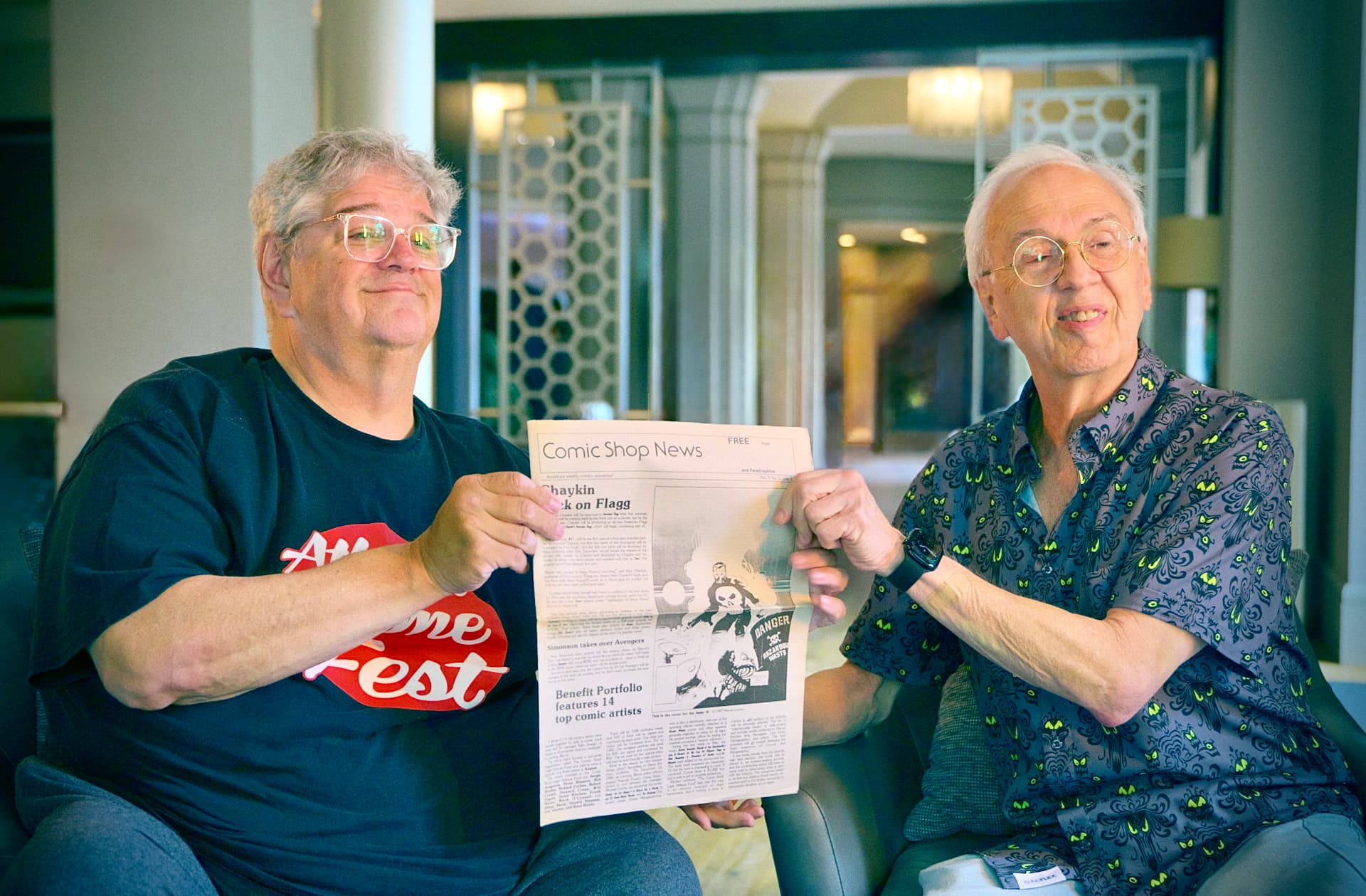 Cliff Biggers and Ward Batty holding the first issue of Comic Shop News