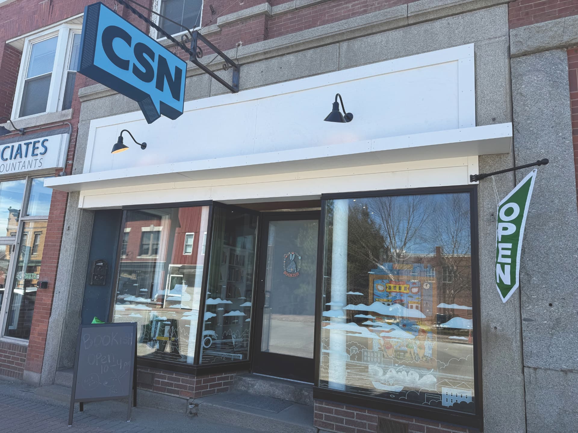 The CSN HQ storefront in Skowhegan, Maine, with a blue CSN word balloon sign