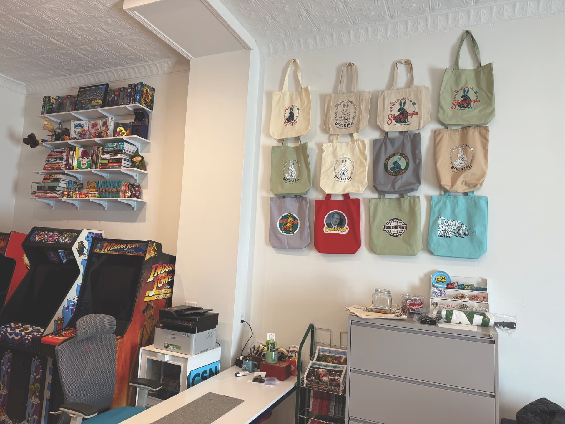 A wall of CSN and Bookish tote bags at CSN HQ