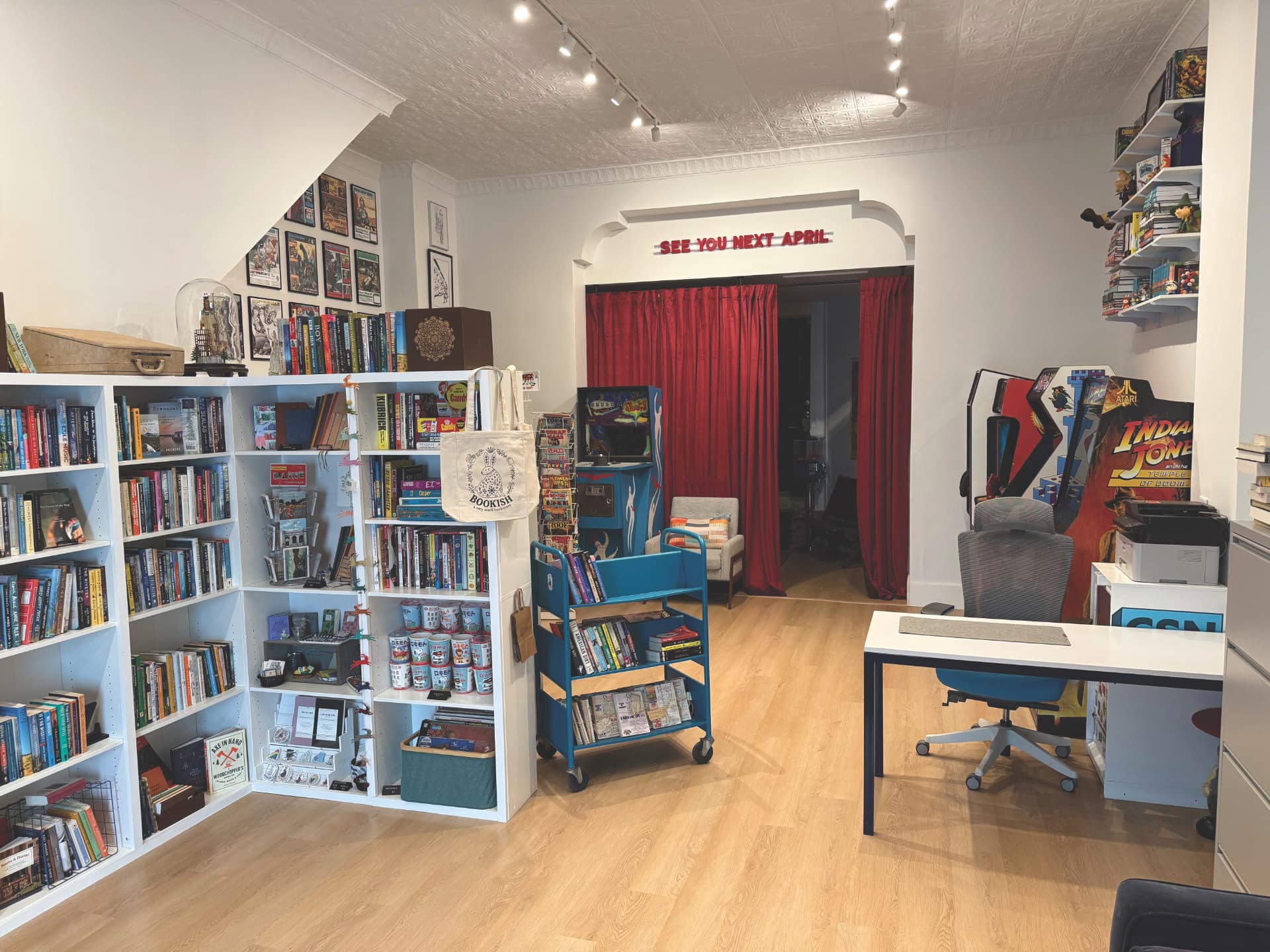 Inside CSN HQ, shelves of books and a comics cart